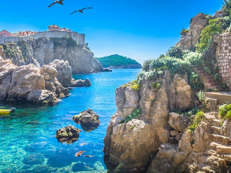 A stunning view of Dubrovnik's Old Town, surrounded by crystal-clear waters and fortified walls.