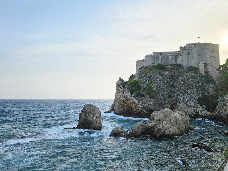 A majestic view of Fort Lovrijenac, the real-life Red Keep from Game of Thrones, perched on a cliff overlooking the Adriatic Sea in Dubrovnik, Croatia.