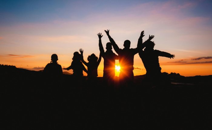 Group of people enjoying a tour at sunset.