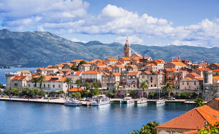 A picturesque image of Korčula's iconic city walls and harbor.