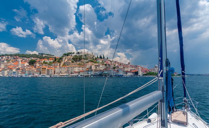 A stunning view of Šibenik, Croatia from the sea, with colorful houses and a historic fortress.