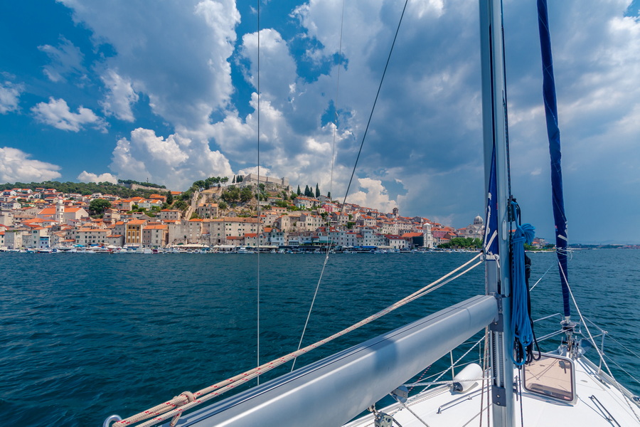 A stunning view of Šibenik, Croatia from the sea, with colorful houses and a historic fortress.