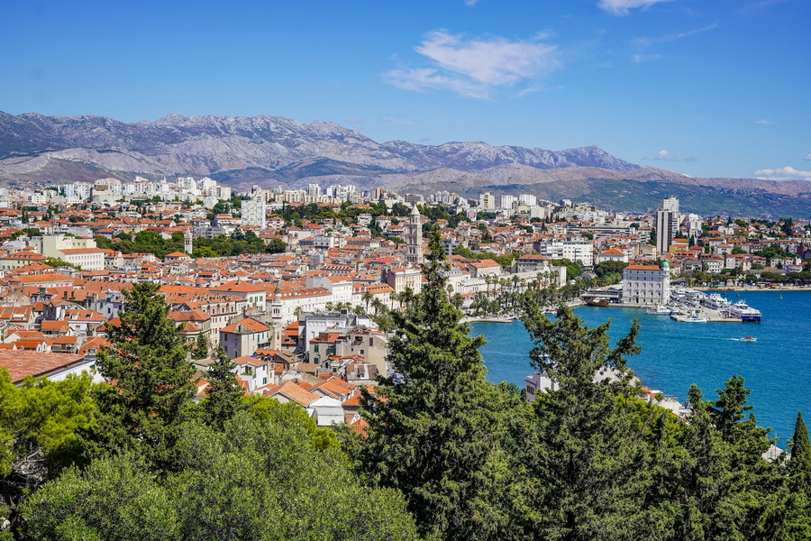 A stunning panoramic view of Split, Croatia, with the Adriatic Sea and mountains in the background.