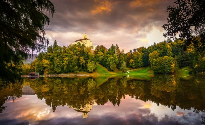 A stunning view of Trakošćan Castle, Croatia, reflecting on a calm lake.