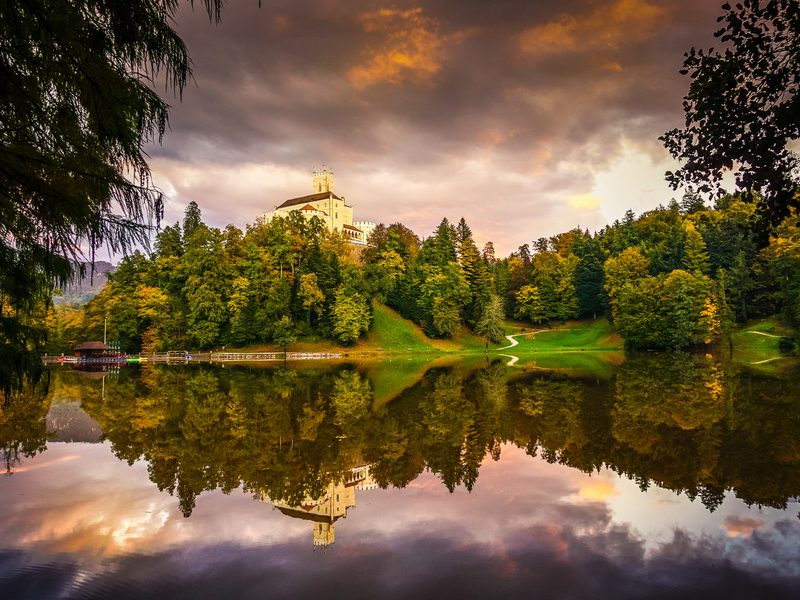 A stunning view of Trakošćan Castle, Croatia, reflecting on a calm lake.