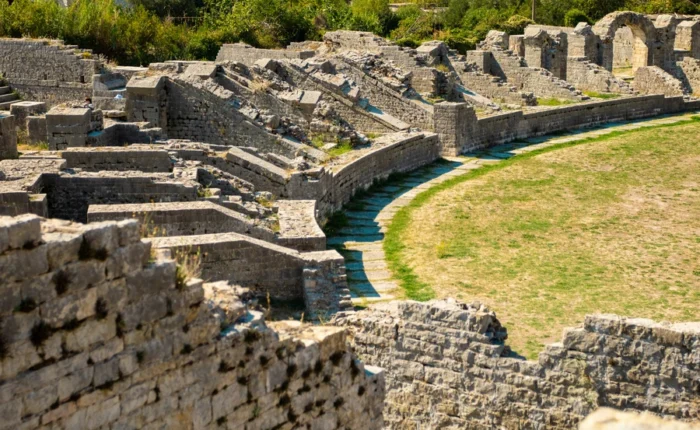 Ancient stone ruins and seating of the Roman amphitheatre in Solin (Salona), Croatia, surrounded by greenery - remarkable archaeological site and hidden historical treasure near Split.