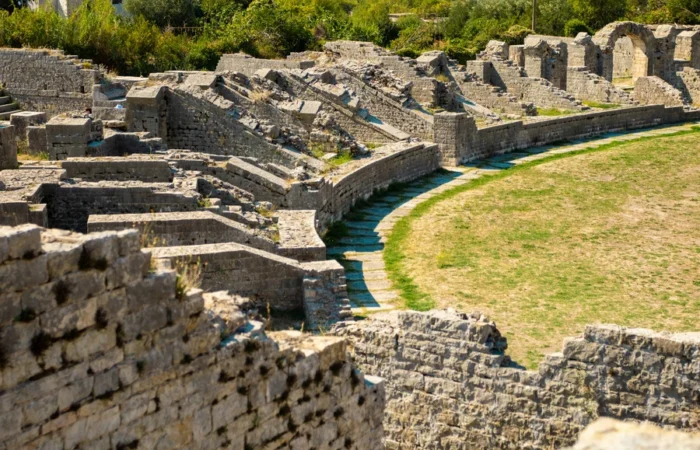 Ancient stone ruins and seating of the Roman amphitheatre in Solin (Salona), Croatia, surrounded by greenery - remarkable archaeological site and hidden historical treasure near Split.