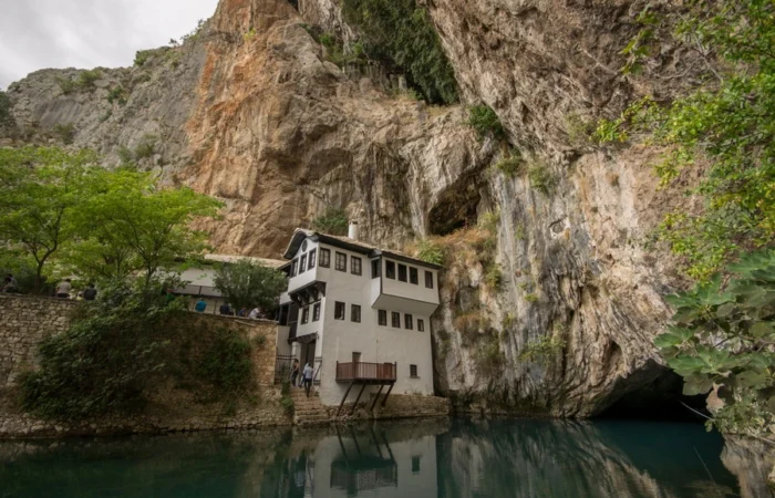 The historic Dervish monastery (Blagaj Tekke) perched beside the emerald Buna River spring and dramatic cliffs in Blagaj, Bosnia and Herzegovina.