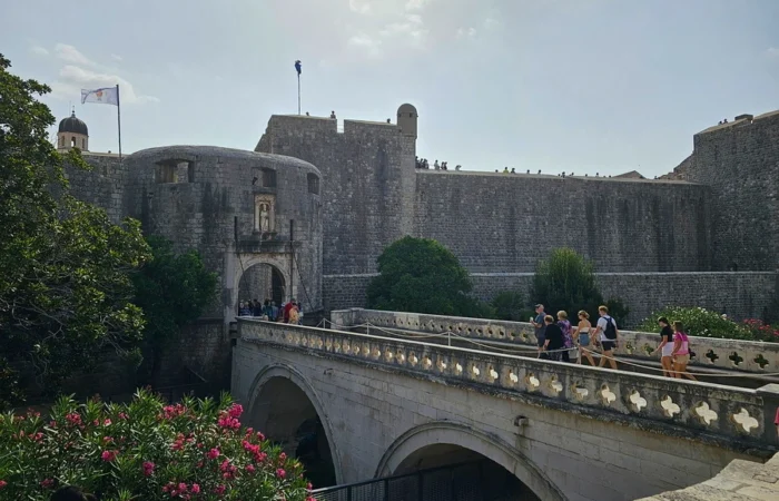 Pile Gate in Dubrovnik, bustling with tourists, iconic city walls, and a stone bridge-filming location for the entrance to King’s Landing near the Red Keep in Game of Thrones.