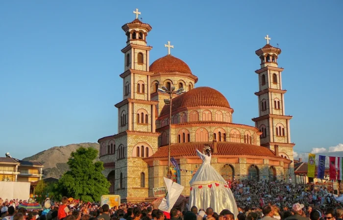 The Resurrection of Christ Orthodox Cathedral with red domes and twin bell towers rises over a crowd during a lively celebration in Korçë, Albania.