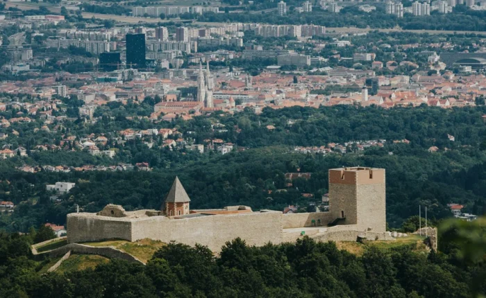 Aerial view of Medvedgrad medieval fortress on Medvednica Mountain with the city of Zagreb spread out in the background.
